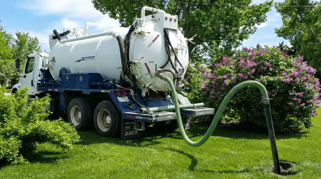 Professional vacuum truck performing residential drainage and septic maintenance in Worcester, MA